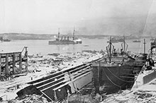 The Halifax Explosion of 6 December 1917 devastated the harbour, but Niobe amazingly survived and can be seen raising steam at the right of this photo.