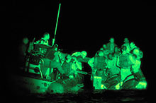 A night vision scope view from the frigate Winnipeg of her boarding party intercepting a boat of Somali pirates, April 2009.