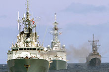 Sailing into the future: Her Majesty’s Canadian Ships Regina (in the lead, gun firing) and Algonquin, with an American frigate during Exercise Trident Fury 2007.