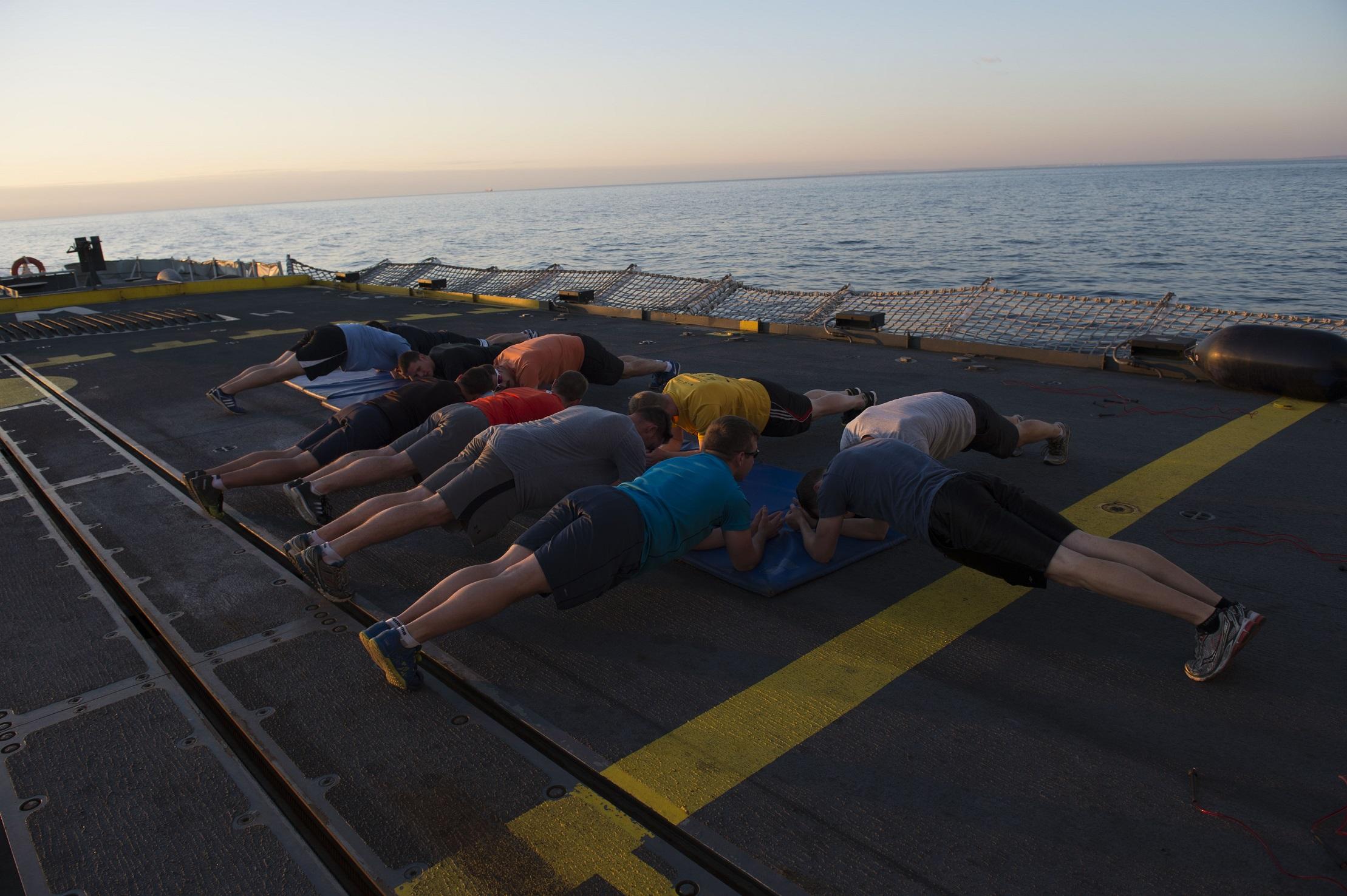 Members of HMCS Winnipeg participate in one of the ship’s sunset fitness classes led by PSP instructor, Sylvain Verrier.