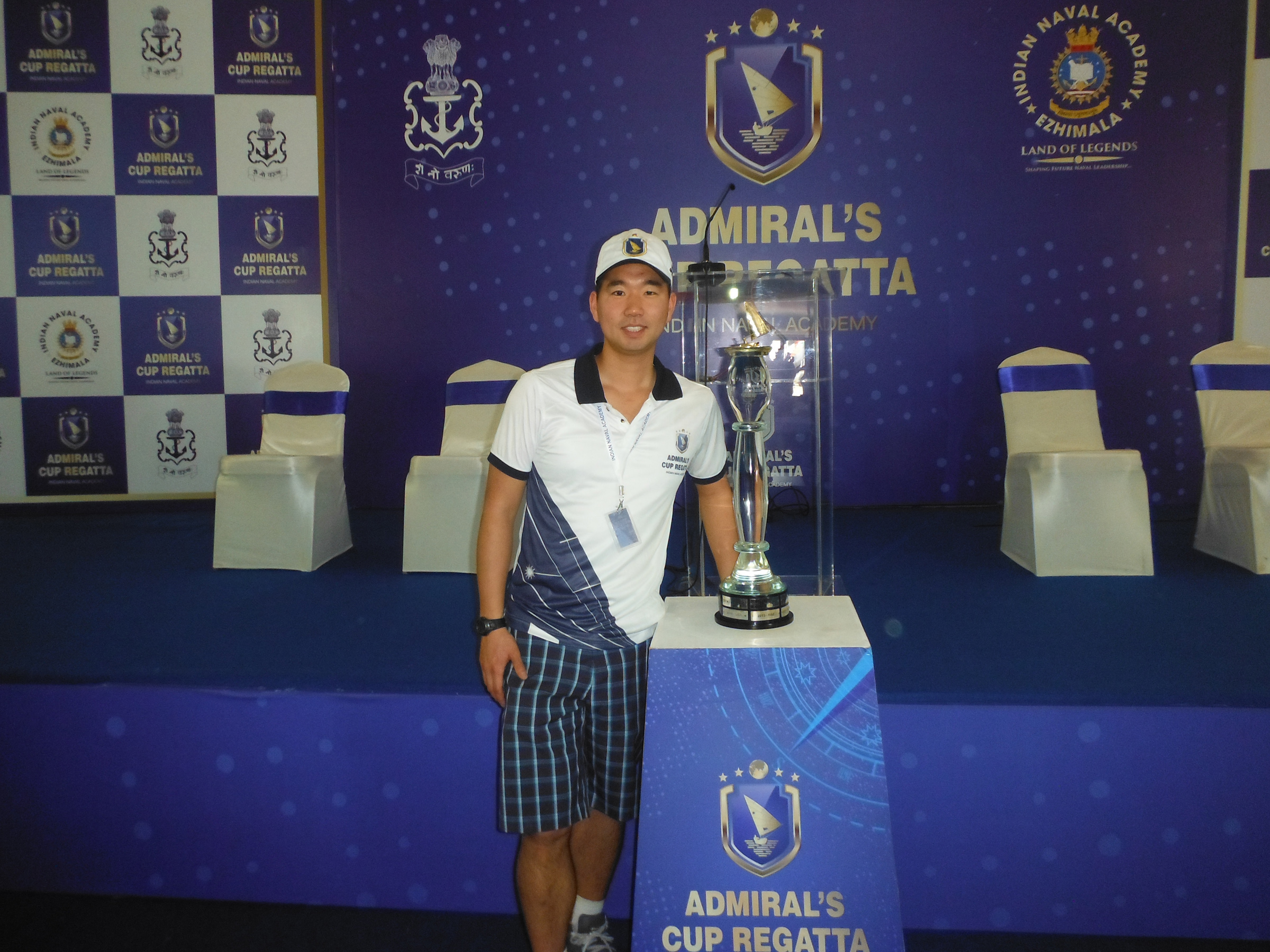 Lieutenant (Navy) James Lee, an Above Water Warfare Training Officer at Naval Fleet School (Pacific), poses with the Admiral’s Cup Regatta Trophy in Kerala State, India.