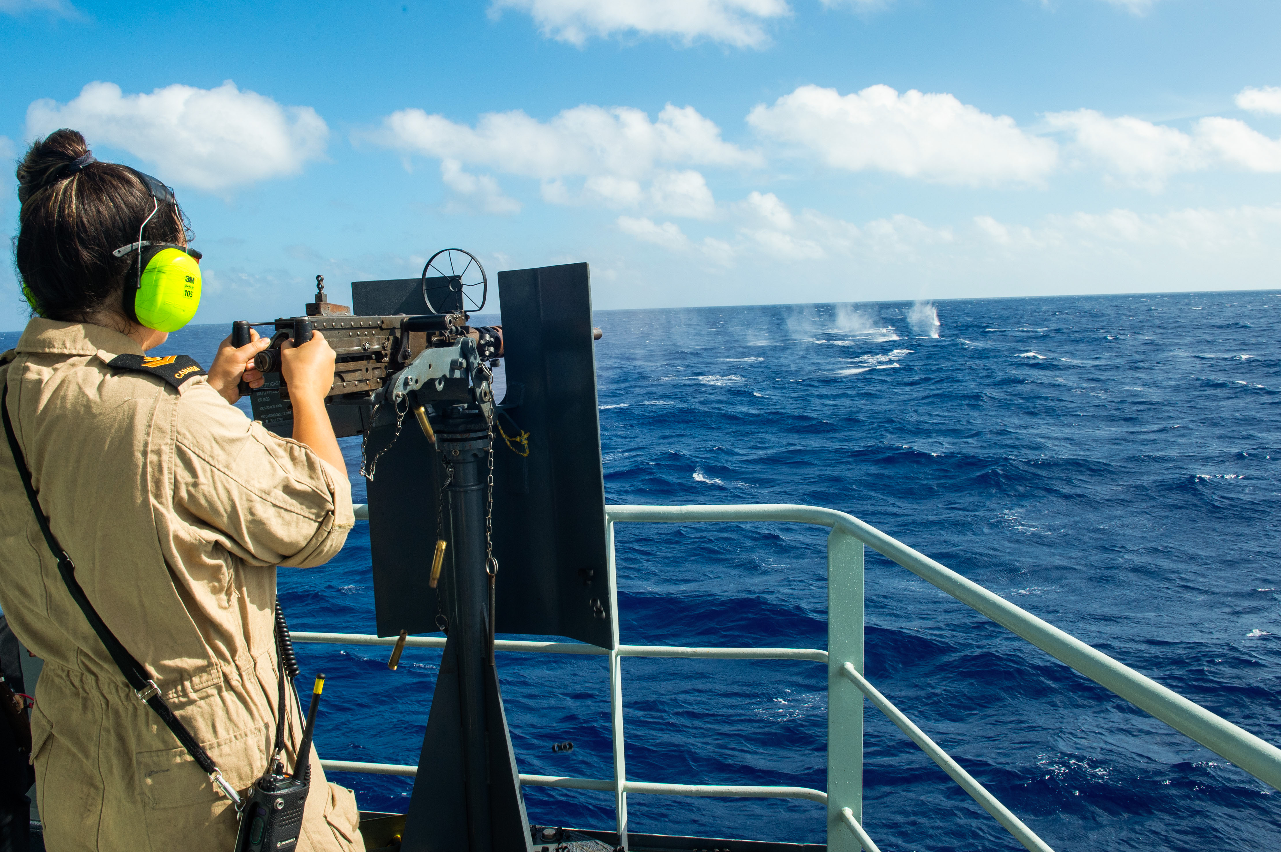 A crew member from HMCS Summerside operates the .50 cal machine gun