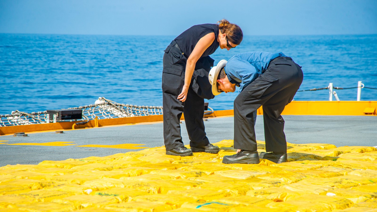 Crew members of HMCS Calgary prepare narcotics for disposal