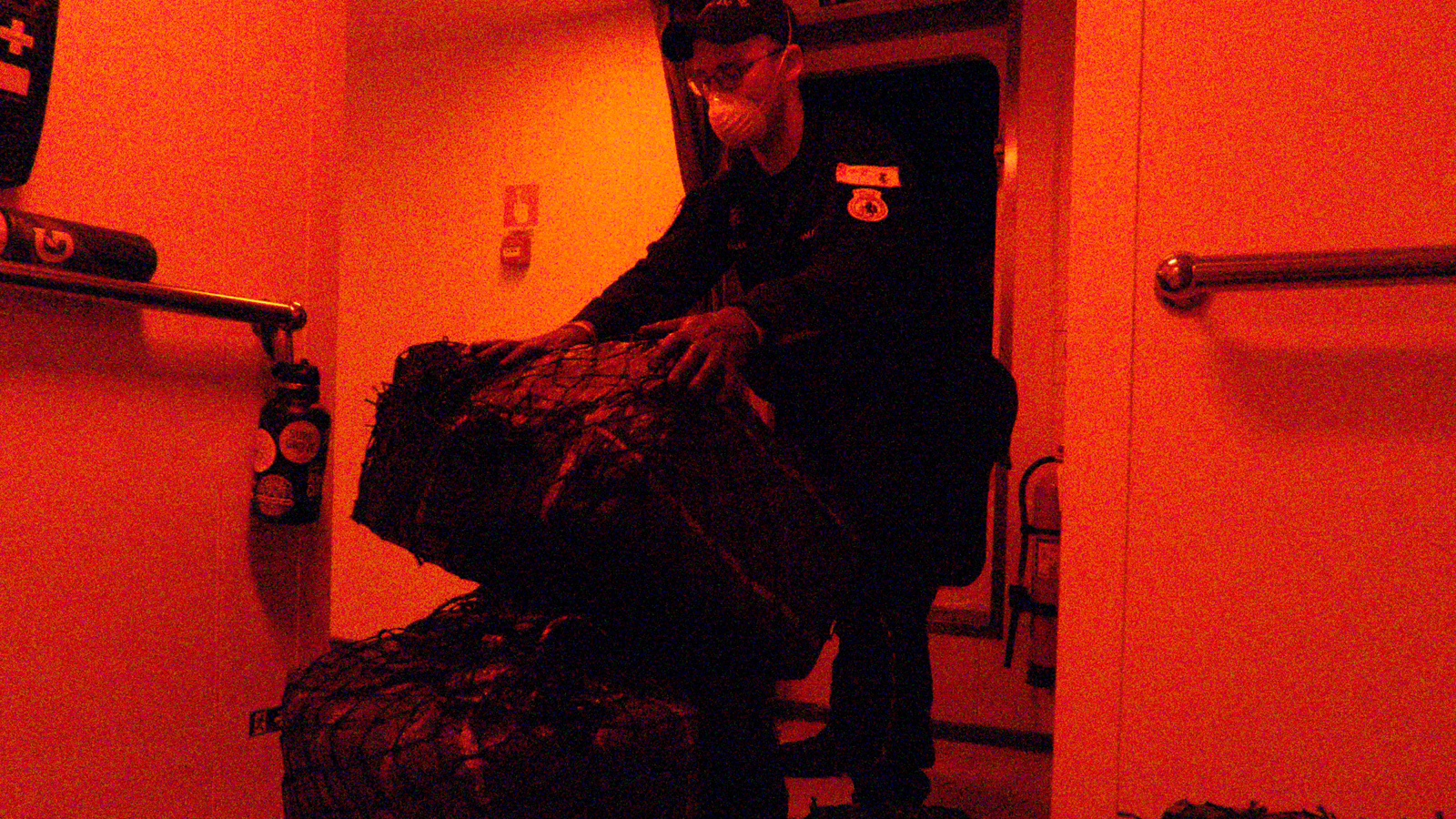 A sailor on board HMCS Harry DeWolf handles seized narcotics