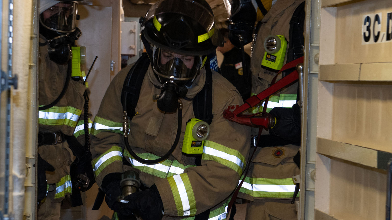Sailor 2nd Class Alicia Campbell stands ready to fight a simulated fire